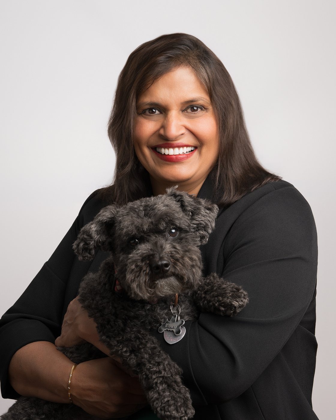 Portrait of Aurita holding her dog