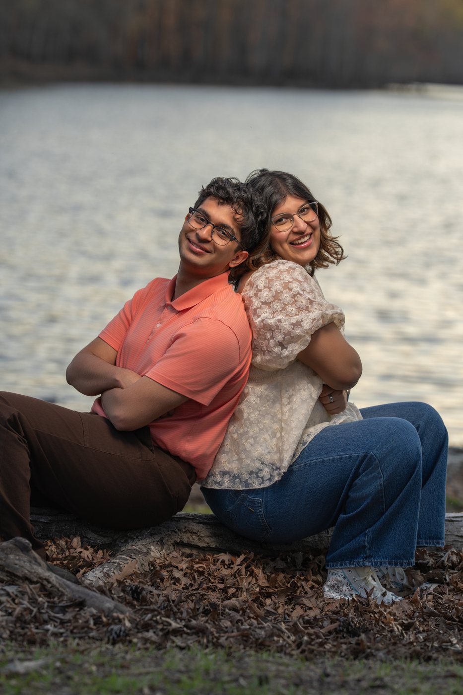 Aurita's children sitting back to back by the water